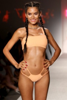 MIAMI BEACH, FL - JULY 22: A model walks the runway during the SWIMMIAMI Frankie's Bikinis 2018 Collection fashion show at the SWIMMIAMI tent on July 22, 2017 in Miami Beach, Florida. (Photo by Alexander Tamargo/Getty Images for SWIMMIAMI)